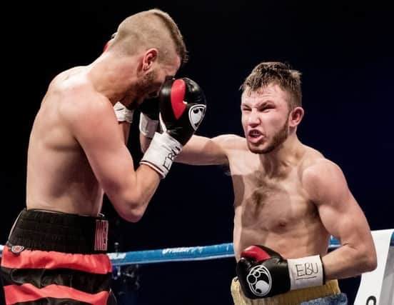 Isaac Lowe goes on the attack against Dennis Ceylan.