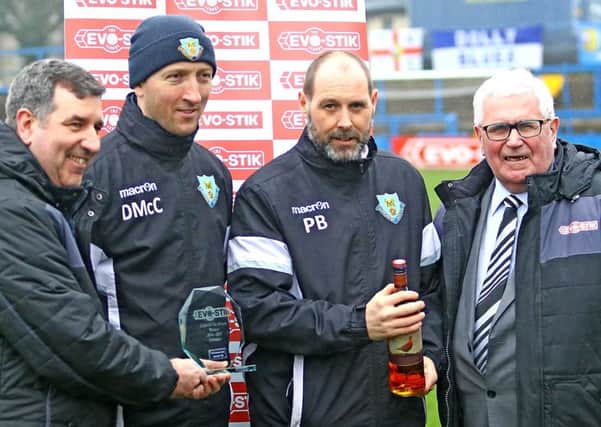 Manager Phil Brown and Dave McCann are presented with the team of the month award for February. Picture: Tony North