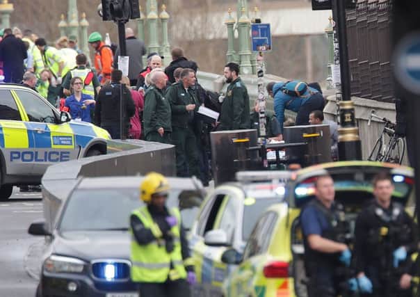 Emergency personnel close to the Palace of Westminster, London, after policeman has been stabbed and his apparent attacker shot by officers in a major security incident at the Houses of Parliament. PRESS ASSOCIATION Photo.