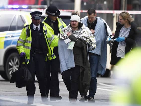 Owen Lambert from Morecambe is treated by emergency services near Westminster Bridge.  (Photo by Carl Court/Getty Images)