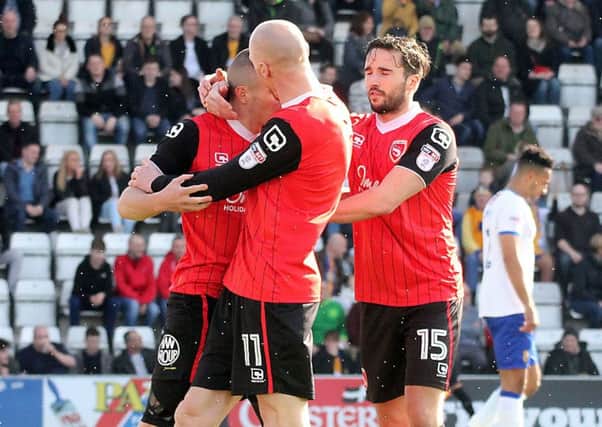 Paul Mullin is congratulated on his goal against Mansfield.