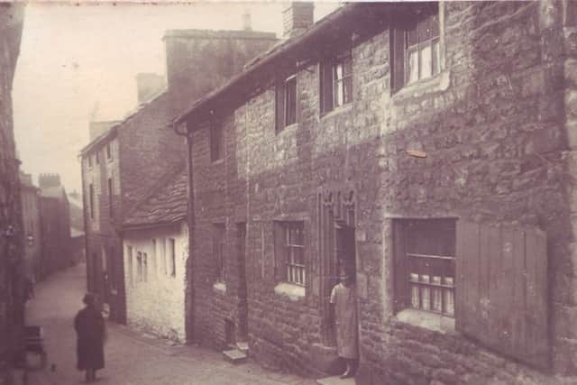 Dan Wright family collection of old photographs. This picture shows Bridge Lane, Lancaster (top) and bottom picture shows a house with a woman in the doorway known as 'The House with the Studded Door' dated 1694.