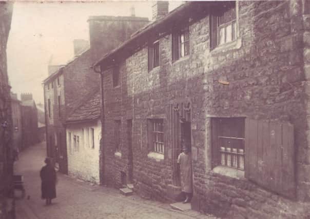 Dan Wright family collection of old photographs. This picture shows Bridge Lane, Lancaster (top) and bottom picture shows a house with a woman in the doorway known as 'The House with the Studded Door' dated 1694.