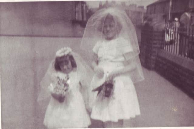 Taken from Ann Burgess's collection of St Joseph's Catholic Primary School in Lancaster. This picture shows Ann's sister Sylvia Rutlidge with her daughter Susan in the school yard.