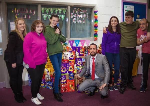 Rachel Leinweber (left) and James Turver (kneeling) from Reed Accountancy with Kimberley Brocklebank (third right, childcare and daytime services manager) and young people at Unique Kidz & Co.