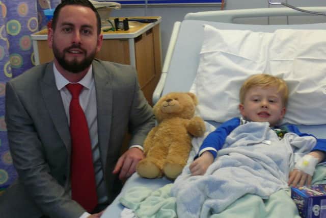 James Turver from Reed with a young patient at the Royal Lancaster Infirmary.