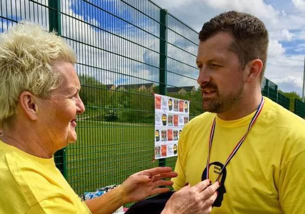 Danny Carlton, Morecambe FC's Wembley hero, gets a medal from Councillor Margaret Pattison at Saturday's Defying Dementia charity football match.