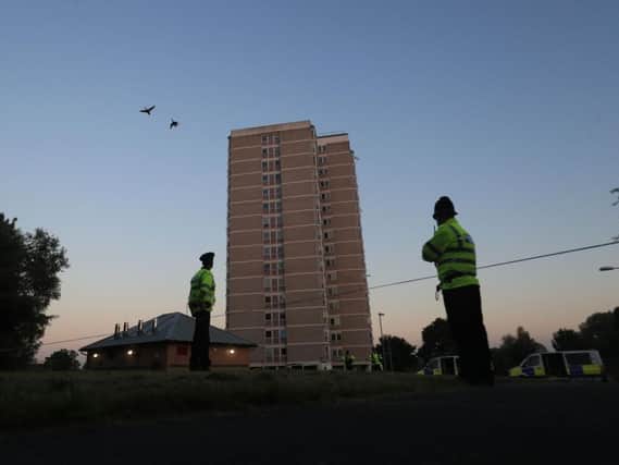 Police outside a block of flats they raided in Blackley, north Manchester, where a woman was arrested. She has since been released without charge.
