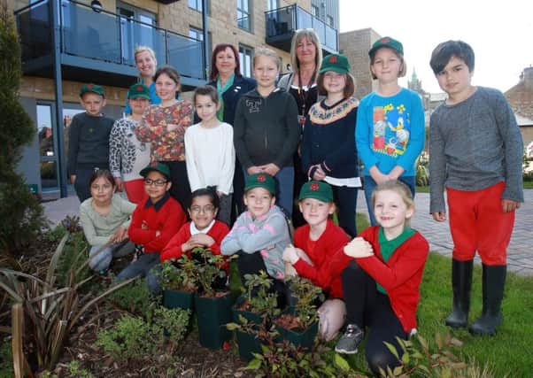 McCarthy & Stone Sales Executive Colette Grainger and Bowerham Primary School Teachers Emma Oliver and Adele Wilkinson and pupils Warren, Taylor, Lili, Bethany, Vicky, Emma, Mable, Sam, Freya, Adam, Aamina, Viki, Esme and Imogen planting a Lancashire Rose at Williamson Court, Lancaster. 

credit:  leeboswellphotography.com