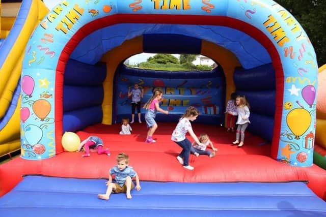Children enjoying the bouncy castle at Alannafest. Photo by Mike Jackson.