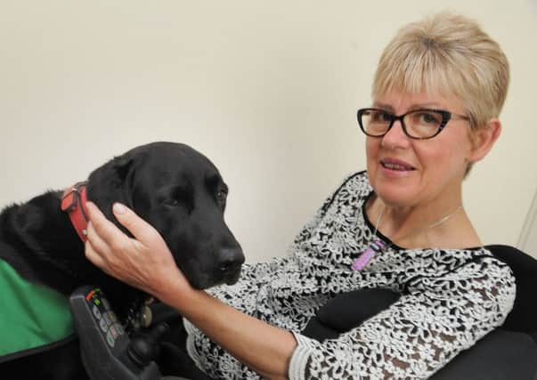 Lynn Matthews, of Longlands Avenue in Heysham, is disabled and is helped in her day-to-day life by her assistance dog Christa, a black labrador.  PIC BY ROB LOCK
9-5-2017