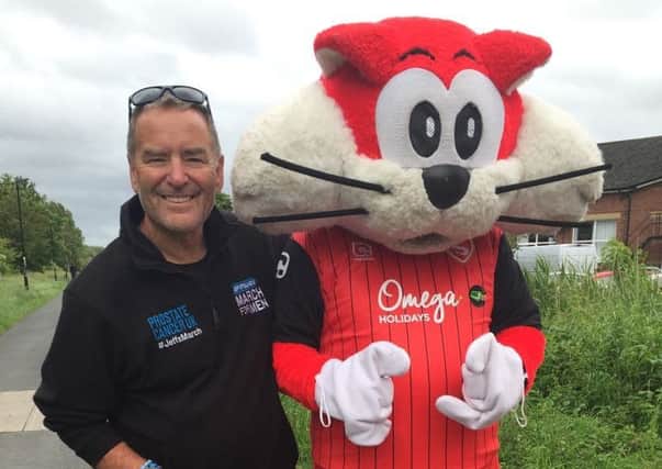 Sky Sports presenter Jeff Stelling with Morecambe FC mascot Christie the Cat.