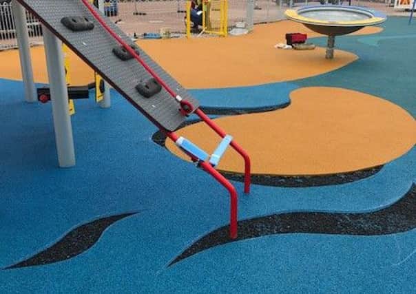 Workmen have had to cut part of the flooring out at a new playground after yobs trampled on it before it was open to the public. Picture: Michelle Blade.