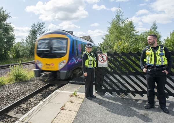 Picture by Allan McKenzie/YWNG - 30/07/15 - Press - Mirifeld Rail Safety - Mirfield Rail Station, Mirfield, England - British Transport Police's Jacqui Wilson & Carl Hall at Mirfield station, raising awareness of the danger of trespassing on train lines.