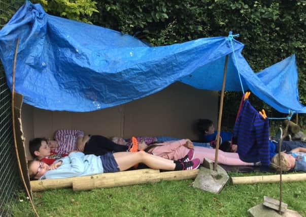 St Francis' pupils having a well earned nap after building dens.