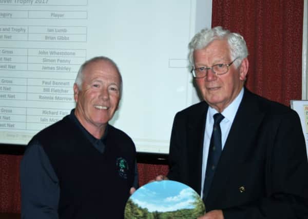 Silverdale golfer Brian Gibbs is pictured receiving his award from Dr David Marsh.