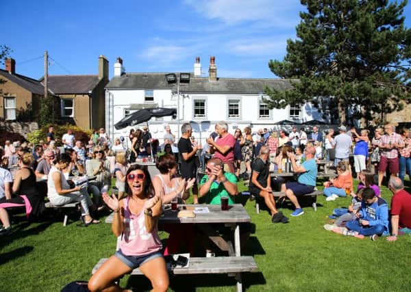 MORECAMBE MUSIC FESTIVAL: People enjoying music in the sun in the Morecambe Hotel beer garden. Photo by Mike Jackson.