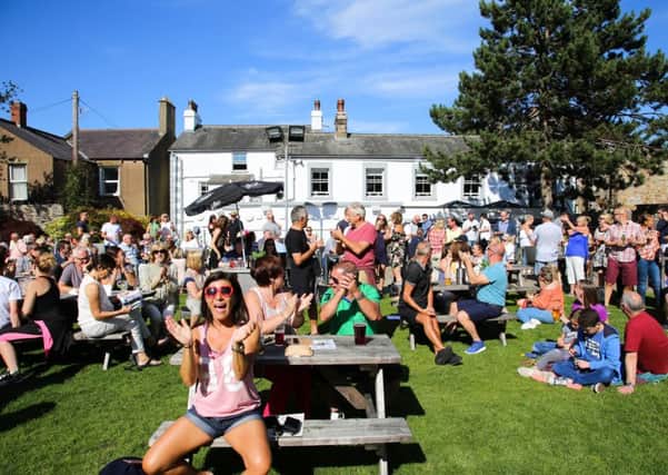 People enjoying music in the sun in the Morecambe Hotel beer garden at last Saturday's Morecambe Music Festival. Photo by Mike Jackson.