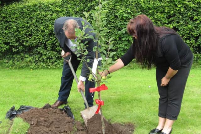 Graham Wilson (Chriss dad) and Paula Smith planting the tree.