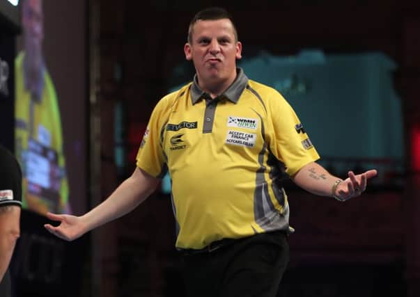 Dave Chisnall celebrates on his way to victory over Mervyn King on Sunday night.  Picture: Lawrence Lustig