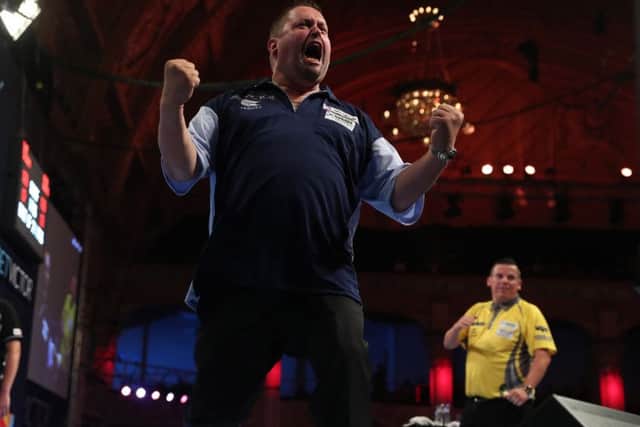 Alan Norris celebrates on his way to victory over Dave Chisnall. Picture: Lawrence Lustig