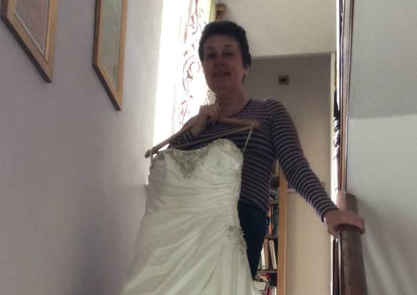 Amanda Flattery showing off a beautiful wedding dress which has been donated for the event.