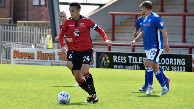 New Morecambe captain Michael Rose in action against Rochdale.
