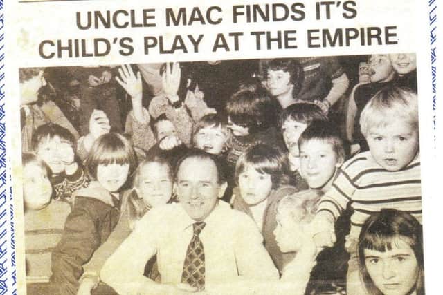 A newspaper cutting of Douglas 'Mac' MacGregor and children from his kids club at the Empire Cinema in Morecambe.