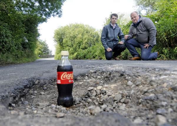 Josh Hocking and Dan Thornton from Ocean Edge Caravan Park say the council are doing nothing about pot holes on Moneyclose Lane
