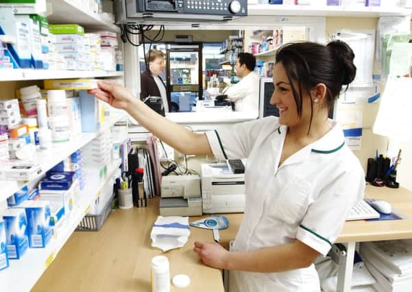 A pharmacist finds the medication for a patient's prescription.