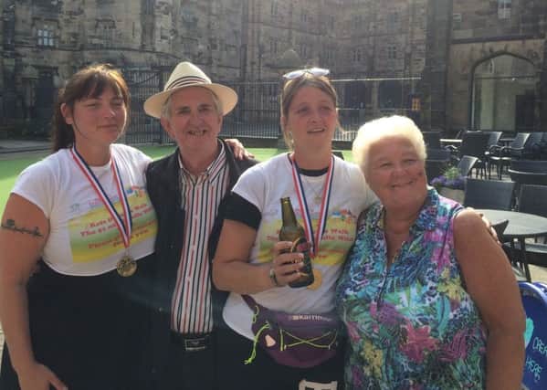 Kate Hyde and Beckie Smith with Leon and Babs Curtis, founders of Donna's Dream House. Friends Katie and Beckie walked 51 miles from Pendle to Lancaster Castle to raise money for the charity.