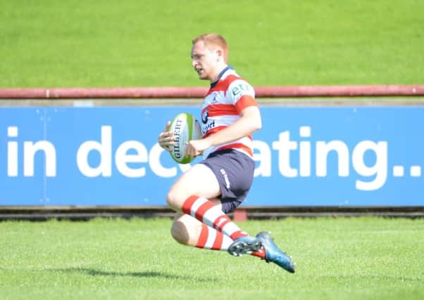 hat-trick hero Damon Hall crosses for one of his three tries.