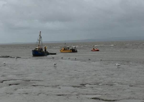 The fishing boat being towed to safety by Morecambes inshore lifeboat.