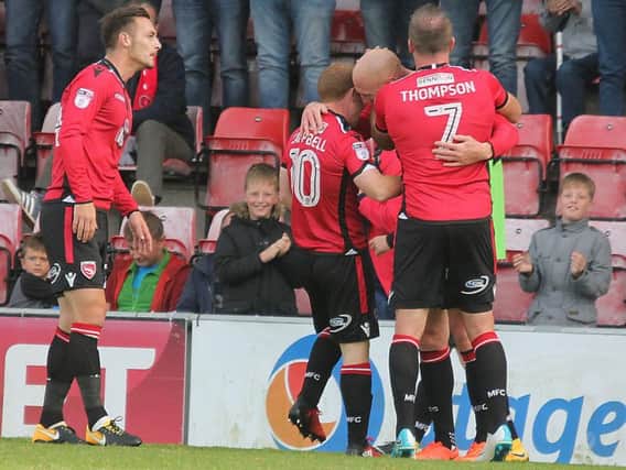 Kevin Ellison is congratulated on his second goal of the afternoon.