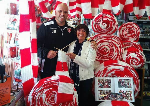 Jim Bentley, Morecambe FC manager, with Barbara Boyd from the Little Shop of Hobbies and the giant Shrimps scarf.