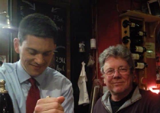 David Miliband pulls a pint at the Gregson Centre watched by Graeme.