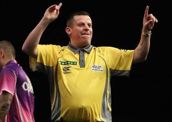 Dave Chisnall celebrates victory over Jelle Klaasen in the opening round of the Unibet World Grand Prix.