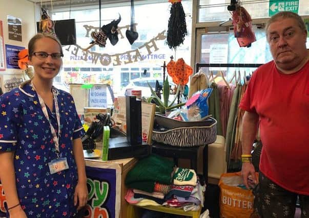 Claire Fox, hospital play specialist at the RLI, with manager of Crazy Cats charity shop Mark West, which has donated toys to the children's ward after they were stolen.