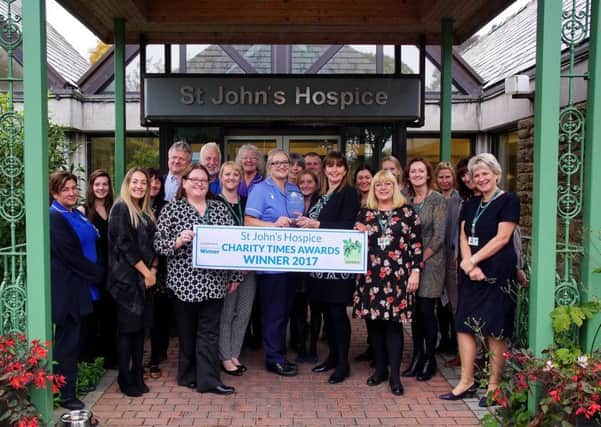St John's Hospice staff and volunteers in Lancaster celebrate receiving the award.