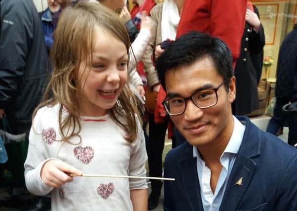 Conductor Jonny Lo and six-year-old Erin Roberts, who took over as conductor of the Haffner Orchestra in St Nicholas Arcades, Lancaster.