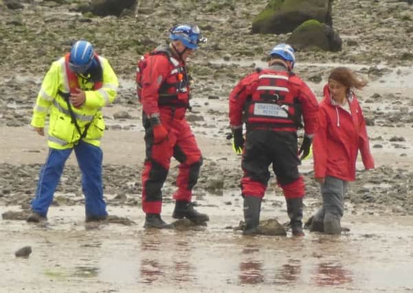 Rescuers with the woman who became trapped in quicksand in Morecambe. Picture by Mark McGlinchey.