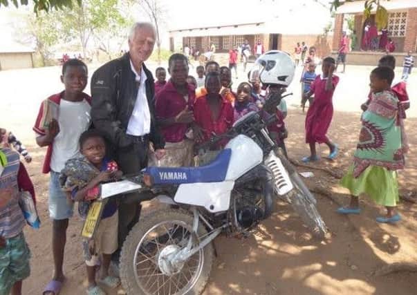 Mike Barnes in Malawi with some of the children.
