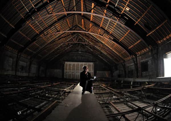 Ian Bond inside the roof space which could become a new venue for entertainment. Photo by Neil Cross.