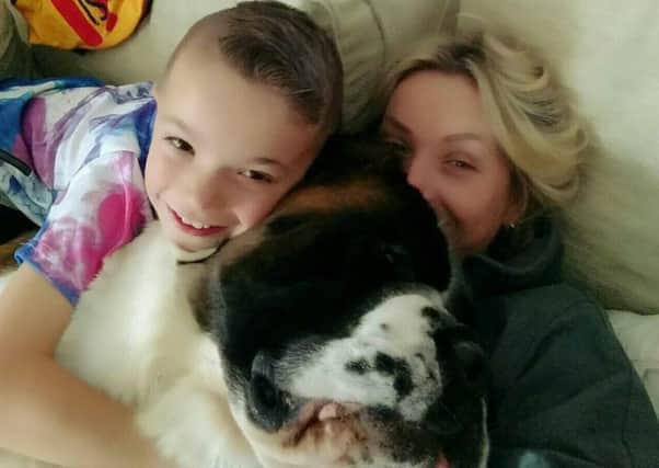 Harry Westwood, eight, with his mum Dani and pet dog, Betty, a blind St Bernard.