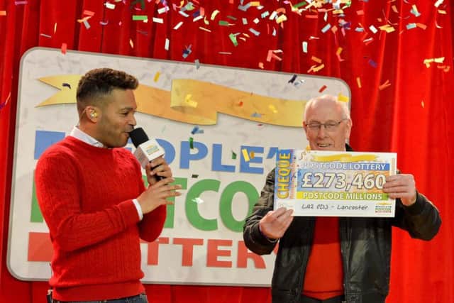 Pictured at Glasson Dock are the Peoples Postcode Lottery winners from postcode LA2 0 receiving their winner's cheques. Shown receiving his cheque from Ambassador Danyl Johnson is Charles Bostock. Pictures Copyright Darren Casey / DCimaging 07989 984643