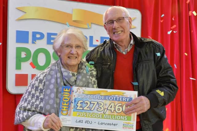 Pictured at Glasson Dock are the Peoples Postcode Lottery winners from postcode LA2 0 receiving their winner's cheques. Shown receiving his cheque from Ambassador Danyl Johnson is Charles and Enid Bostock.  Pictures Copyright Darren Casey / DCimaging 07989 984643