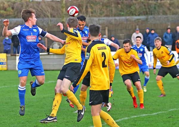 Craig Carney and Steve Williams battle in the air during Lancaster City's win over Mildenhall Town. 

Picture: Tony North