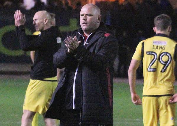 Jim Bentley saultes the Morecambe fans after the draw at Carlisle.
