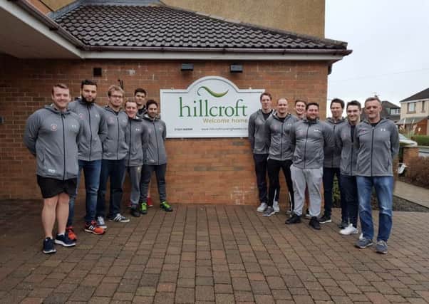 The Lancaster City team stand outside Hillcroft Nursing Home, who sponsor their kit.