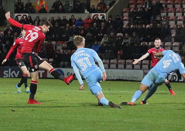 Callum Lang scores Morecambe's second goal in the win over Coventry.